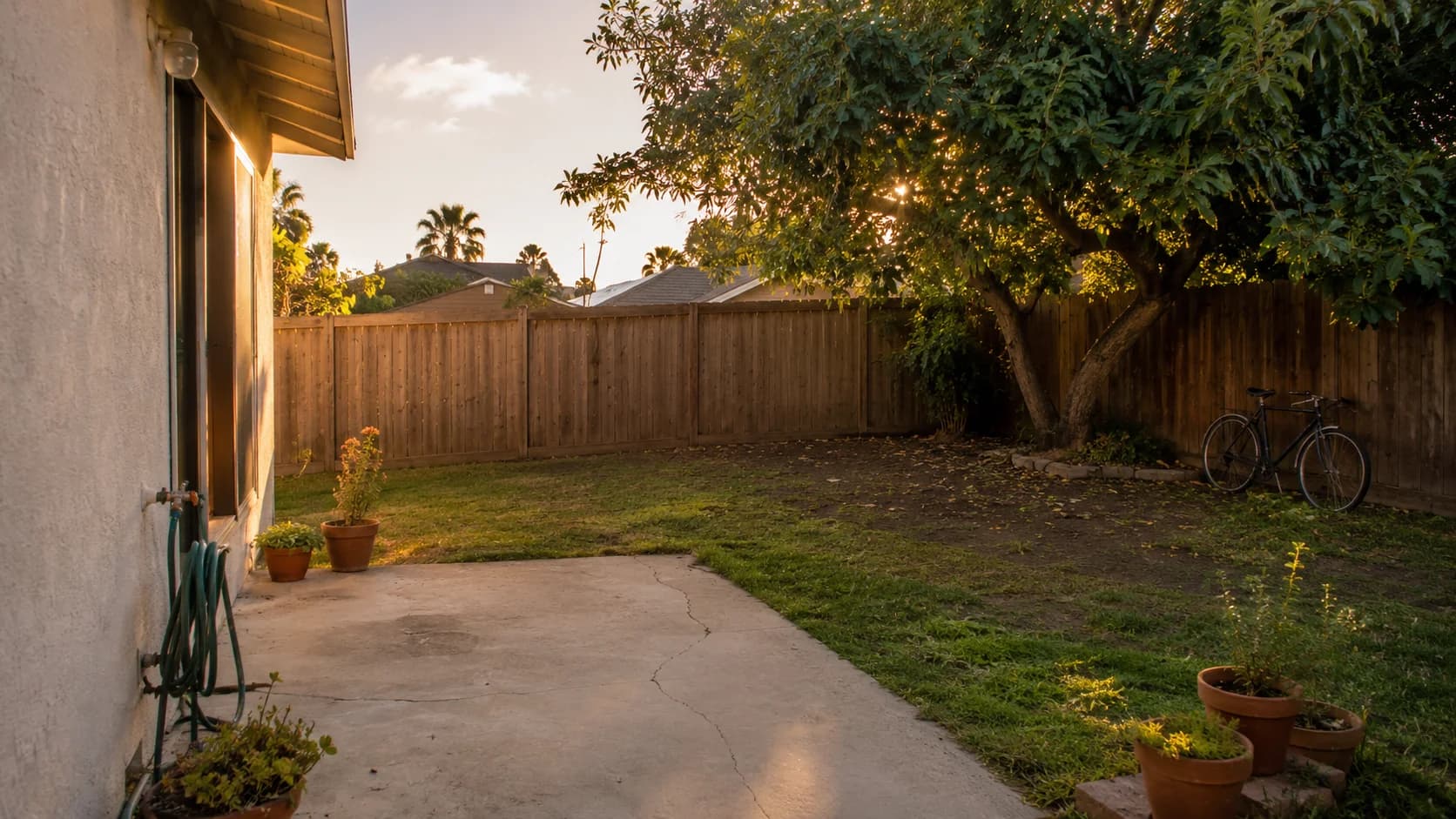 A San Diego residential backyard, lived in but not yet designed. Illustrative.